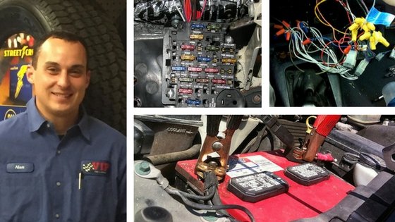 Technician in blue uniform with circuit board and electronic components displayed in surrounding.