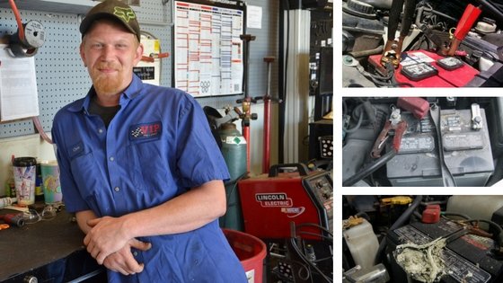 Mechanic in blue work shirt stands in garage with tools and equipment visible in background.