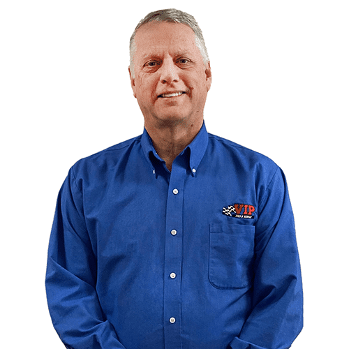 Middle-aged man wearing a blue button-up shirt with a small logo on the chest.