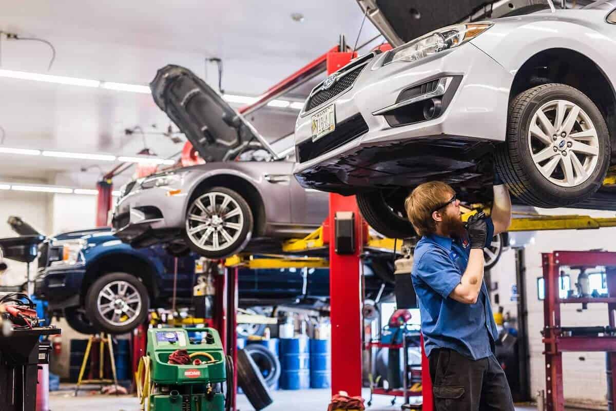 3 cars lifted to be worked on in a VIP Auto repair shop