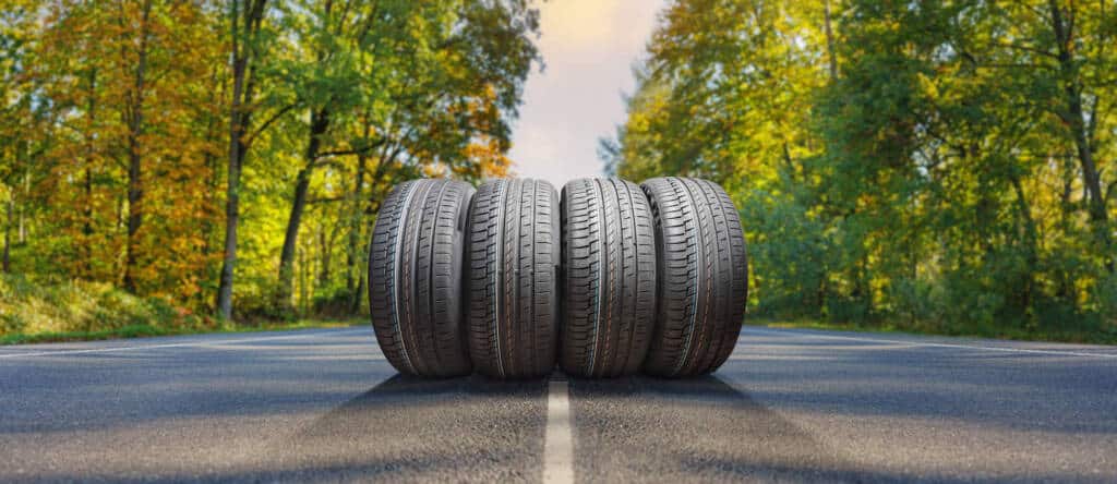 four tires lined up in the middle of the road