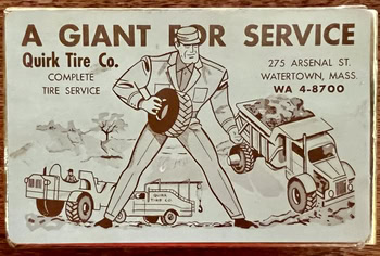 Vintage advertisement for Quick Tire Co. showing a giant man standing over service vehicles.