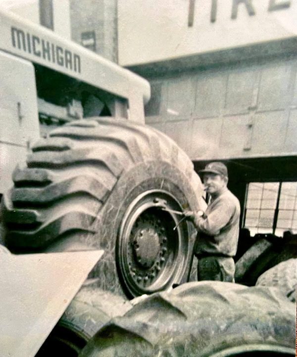 man fixing a tire from 1936