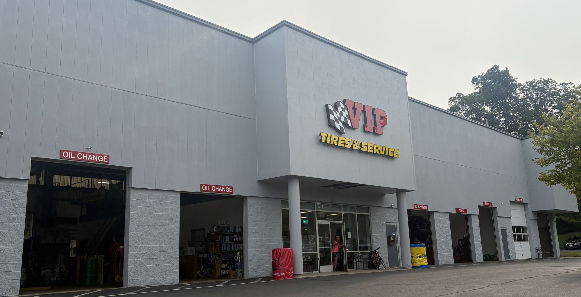 VIP Tires & Service automotive shop with oil change bays and storefront entrance.