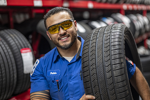 Technician holding a Vredestein tire